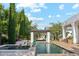 Stunning pool and spa area, complete with a pergola, water features and lush landscaping at 2748 E Warbler Rd, Gilbert, AZ 85297
