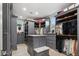 Spacious walk-in closet with custom gray cabinets, drawers, shelving, and a center island at 2748 E Warbler Rd, Gilbert, AZ 85297