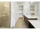 Bathroom featuring double vanity, walk-in closet, and glass shower at 3131 N Central Ave # 3009, Phoenix, AZ 85012