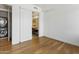 Bedroom with wood floors showing access to the ensuite bathroom and laundry closet at 3131 N Central Ave # 3009, Phoenix, AZ 85012