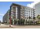 Modern apartment building with gray and white facade, balconies, and manicured landscaping on a sunny day at 3131 N Central Ave # 3009, Phoenix, AZ 85012