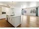 Modern kitchen and living area featuring an island, hardwood floors, stainless steel appliances, and natural light at 3131 N Central Ave # 3009, Phoenix, AZ 85012