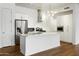 Bright kitchen featuring white cabinetry, stainless steel appliances, an island with a sink, and modern lighting at 3131 N Central Ave # 3009, Phoenix, AZ 85012