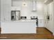 Modern kitchen featuring an island, stainless steel appliances, white cabinets, and hardwood floors at 3131 N Central Ave # 3009, Phoenix, AZ 85012