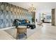 Stylish lobby featuring a plush sofa, patterned wallpaper, and a modern chandelier, creating a welcoming atmosphere at 3131 N Central Ave # 3009, Phoenix, AZ 85012