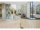 Modern lobby featuring light wood floors, concrete columns, and a reception desk with views to a cozy lounge area at 3131 N Central Ave # 3009, Phoenix, AZ 85012