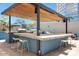 Expansive outdoor kitchen area with dual grills, bar seating, and a shaded pergola at 3131 N Central Ave # 3009, Phoenix, AZ 85012