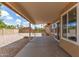 Spacious covered patio with views of the private backyard featuring desert landscaping and block fencing at 325 N Redrock St, Gilbert, AZ 85234
