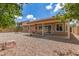 Relaxing backyard featuring desert landscaping and a covered patio for outdoor enjoyment at 325 N Redrock St, Gilbert, AZ 85234