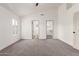 Spacious bedroom with vaulted ceiling and multiple doorways to bathroom and closet at 325 N Redrock St, Gilbert, AZ 85234