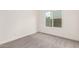 This cozy bedroom features a window and is painted with white neutral colors at 325 N Redrock St, Gilbert, AZ 85234