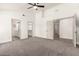 Bedroom featuring vaulted ceiling, ceiling fan and doorways to bathroom and closet at 325 N Redrock St, Gilbert, AZ 85234