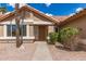 View of the front of a house with desert landscaping and a pathway leading to the front door at 325 N Redrock St, Gilbert, AZ 85234