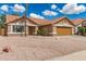 Charming single-story home with a well-kept front yard featuring desert landscaping and a two-car garage at 325 N Redrock St, Gilbert, AZ 85234
