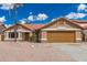 Charming single-story home showcasing a well-kept yard, desert landscaping, and a brown roof at 325 N Redrock St, Gilbert, AZ 85234