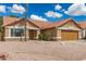 Charming single-story home showcasing a well-kept yard, desert landscaping, and a brown roof at 325 N Redrock St, Gilbert, AZ 85234