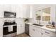 Beautiful kitchen with white cabinets, stainless steel appliances, and elegant backsplash at 325 N Redrock St, Gilbert, AZ 85234