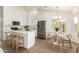 Well-lit kitchen featuring white cabinets, stainless steel appliances, and a cozy dining nook at 325 N Redrock St, Gilbert, AZ 85234