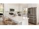Stylish kitchen with white cabinetry, stainless steel appliances, and a spacious quartz countertop island at 325 N Redrock St, Gilbert, AZ 85234