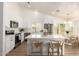 Modern kitchen with white cabinets, stainless steel appliances, and a large island with bar seating at 325 N Redrock St, Gilbert, AZ 85234