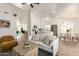 Bright, open-concept living room with modern decor flows into a kitchen and dining area, perfect for entertaining at 325 N Redrock St, Gilbert, AZ 85234