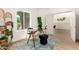 Bright office space with a glass desk, greenery, and an open doorway at 325 N Redrock St, Gilbert, AZ 85234