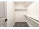 Walk-in closet featuring built-in shelving and carpeted flooring at 325 N Redrock St, Gilbert, AZ 85234