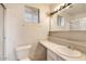 Outdated bathroom featuring a single sink vanity, toilet and a window for natural light at 3410 W Pershing Ave, Phoenix, AZ 85029