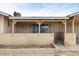 A cozy front porch with a brick barrier and an inviting entrance for guests and residents at 3410 W Pershing Ave, Phoenix, AZ 85029