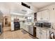 Kitchen featuring white cabinets, tile flooring and appliances with a window view at 3410 W Pershing Ave, Phoenix, AZ 85029