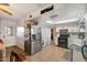 Bright kitchen features tile flooring, stainless refrigerator, and an archway leading to another room at 3410 W Pershing Ave, Phoenix, AZ 85029