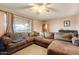 Relaxing living room featuring a sectional sofa, ceiling fan, and natural light at 3410 W Pershing Ave, Phoenix, AZ 85029