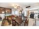 Cozy living room flows into the kitchen, featuring a table and chairs for dining at 3410 W Pershing Ave, Phoenix, AZ 85029