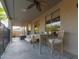 Spacious covered patio with dining table, chairs, sofa, and outdoor living space at 3523 W Buckhorn Trl, Phoenix, AZ 85083