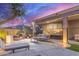 This backyard has a covered patio with nice furniture and grill at sunset at 3523 W Buckhorn Trl, Phoenix, AZ 85083