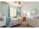 Charming bedroom with soft green walls, a cozy bed, and a view of the attached bathroom at 3523 W Buckhorn Trl, Phoenix, AZ 85083