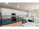 Well-appointed kitchen featuring two-toned cabinets, butcher block countertops, stainless steel appliances, and ample natural light at 3523 W Buckhorn Trl, Phoenix, AZ 85083