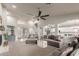 Open-concept living room with vaulted ceilings, a ceiling fan, and seamless transitions to the dining area and kitchen at 3523 W Buckhorn Trl, Phoenix, AZ 85083