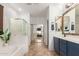 Bright and spacious main bathroom with dual sinks, a soaking tub, a separate shower, and a mirrored closet at 3523 W Buckhorn Trl, Phoenix, AZ 85083