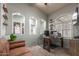 Comfortable home office with a rustic desk, cozy seating area, and unique arched alcoves for decor and personal items at 3523 W Buckhorn Trl, Phoenix, AZ 85083