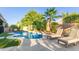 Inviting backyard pool with lounge chairs, lush landscaping and a sunny area for relaxation and enjoying outdoor living at 3523 W Buckhorn Trl, Phoenix, AZ 85083