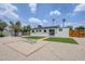 Expansive backyard featuring gravel, artificial turf, a central fire pit, and potential entertainment space at 3609 E Palm Ln, Phoenix, AZ 85008