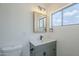 Bright bathroom featuring new vanity with sleek fixtures, cabinet storage, and a window for natural light at 3609 E Palm Ln, Phoenix, AZ 85008