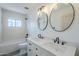 This well-lit bathroom showcases double sinks, modern fixtures, and sleek mirrors above a tiled vanity at 3609 E Palm Ln, Phoenix, AZ 85008