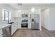 Bright kitchen featuring stainless steel appliances, white cabinets, and a tiled backsplash at 3609 E Palm Ln, Phoenix, AZ 85008