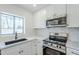 Close up of the spacious kitchen, with stainless steel appliances and a lovely window at 3609 E Palm Ln, Phoenix, AZ 85008
