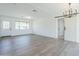 Spacious and bright living area featuring hardwood floors, fresh paint, and a modern light fixtures at 3609 E Palm Ln, Phoenix, AZ 85008