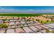 Stunning aerial view of a suburban neighborhood with well-manicured lawns and scenic agricultural backdrop at 36412 W Pampoloma Ave, Maricopa, AZ 85138