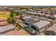 Aerial view of homes in a desert community with solar panels and landscaped yards at 36412 W Pampoloma Ave, Maricopa, AZ 85138