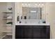 Bathroom features a double sink vanity, shelving for storage, and a large mirror at 36412 W Pampoloma Ave, Maricopa, AZ 85138